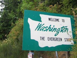 a green and white sign that reads welcome to washington the evergreen state