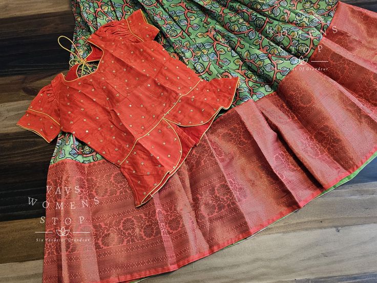 Introducing our stunning Kalamkari Benarasi Silk Lehenga Blouse, the perfect addition to any young girl's wardrobe. Made from high-quality silk and adorned with intricate Kalamkari designs, this lehenga is sure to make a statement at any occasion. Designed to fit girls aged 12-13 years, this lehenga is both comfortable and stylish. The vibrant colors and traditional patterns of Kalamkari make it a versatile piece that can be dressed up or down for any event. At Vavs Women's Stop, we understand t Designer Wear Sharara With Kalamkari Print In Traditional Drape, Designer Wear Sharara With Kalamkari Print, Traditional Sharara With Kalamkari Print For Festive Occasions, Traditional Kalamkari Print Sharara For Festive Occasions, Traditional Kalamkari Sharara For Festive Occasions, Traditional Sharara With Kalamkari Print, Festive Fitted Lehenga With Kalamkari Print, Red Kalamkari Print Lehenga In Traditional Drape, Red Kalamkari Print Lehenga With Traditional Drape