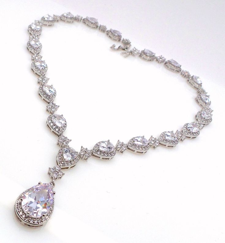 Tarnish resistant white gold plated metal framed teardrop luxury AAA quality clear white cubic zirconia drop. cubic zirconia all around. matching bracelet and earrings available. Size: 16, 17 or 18 inches Backdrop available. Please inquire. matching earrings and bracelet available and sold separately. https://www.etsy.com/listing/587028056/wedding-jewelry-bridal-bridesmaid-gift?ref=shop_home_active_89&pro=1&frs=1 https://www.etsy.com/listing/499680478/wedding-jewelry-bridal-bracelet?ref= Jewelry Prom, Halo Necklace, Prom Jewelry, Pearl Cream, Necklace Wedding, Jewelry Bridal, Matching Bracelet, Bridal Bracelet, Clear White