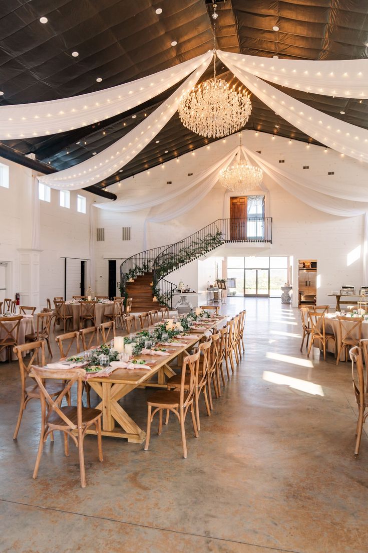 the inside of a large banquet hall with tables and chairs