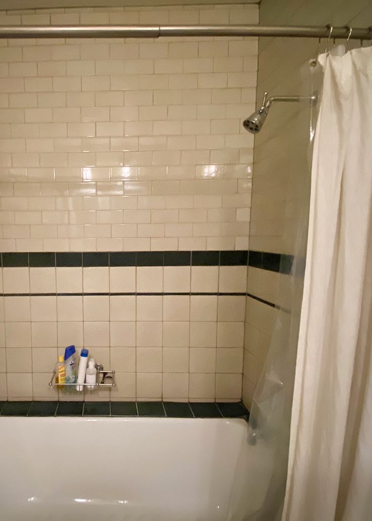 a white bath tub sitting next to a shower curtain