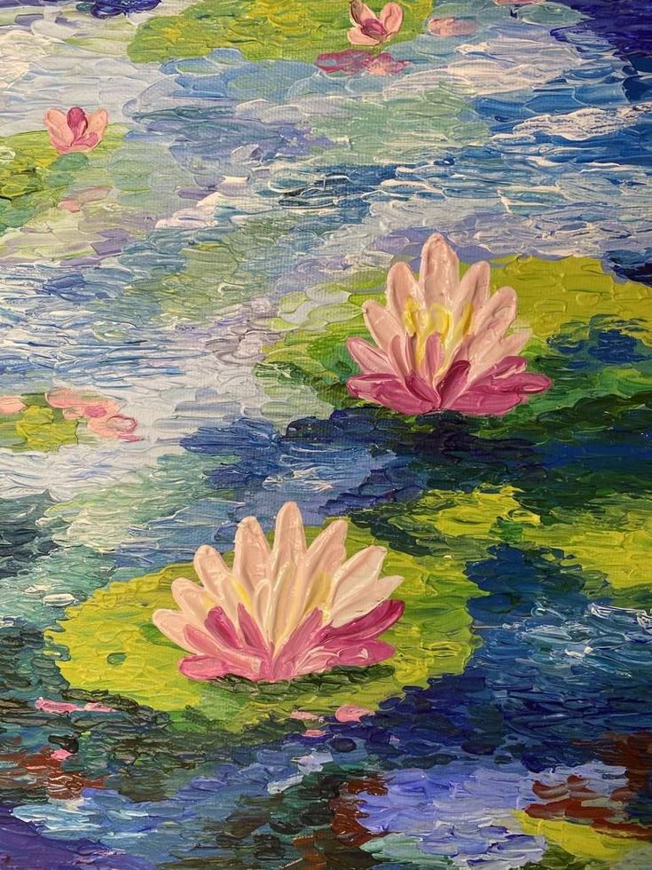 two pink water lilies floating on top of lily pads