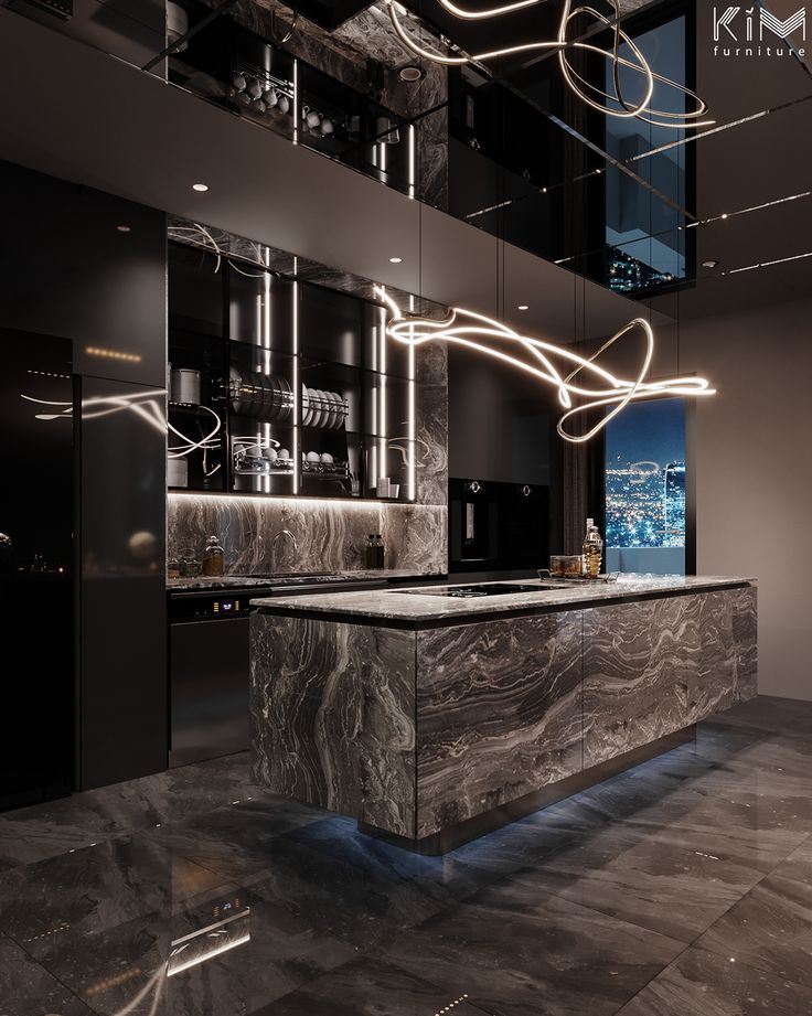 an elegant kitchen with marble counter tops and black cabinets, along with lights hanging from the ceiling