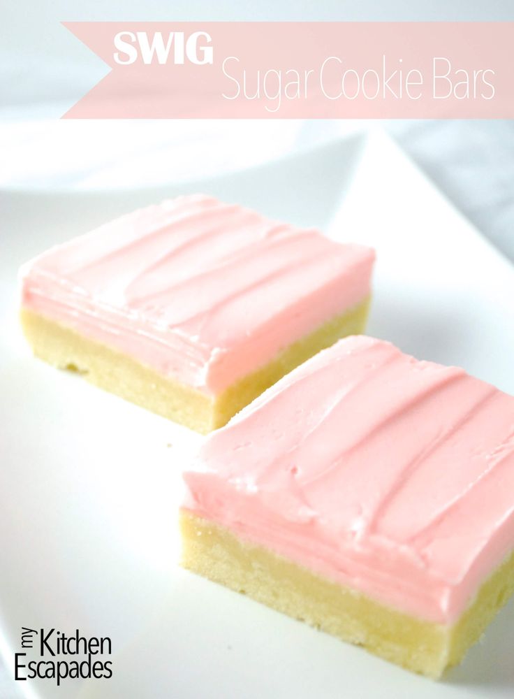 two pieces of cake sitting on top of a white plate next to each other with pink frosting