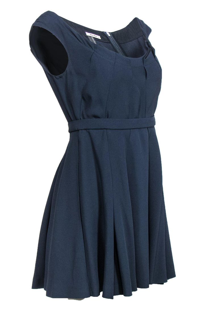 Give a nod to navy in this dress from Miu Miu! This simple yet chic dress is the perfect last minute fix for your next event! Wear it with nude heels and a silver clutch for a timeless look. Size 10 Shell: 74% Acetate, 26% Viscose Lining: 100% Polyester Concealed back zipper Lined Fit and flare silhouette w/ waistband Scoop neckline Sleeveless Pleated Bust 34" Waist 28" Shoulder to hem 32" Navy A-line Evening Dress, Miu Miu Sleeveless Spring Dresses, Sleeveless Miu Miu Spring Dresses, Spring Sleeveless Miu Miu Dresses, Sleeveless Miu Miu Summer Dress, Chic Sleeveless Miu Miu Dress, Miu Miu Fitted Formal Dresses, Elegant Sleeveless Miu Miu Dress, Formal Fitted Miu Miu Dresses