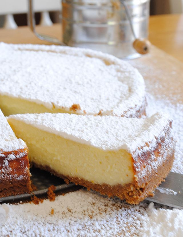 a cake with powdered sugar on top is cut into slices