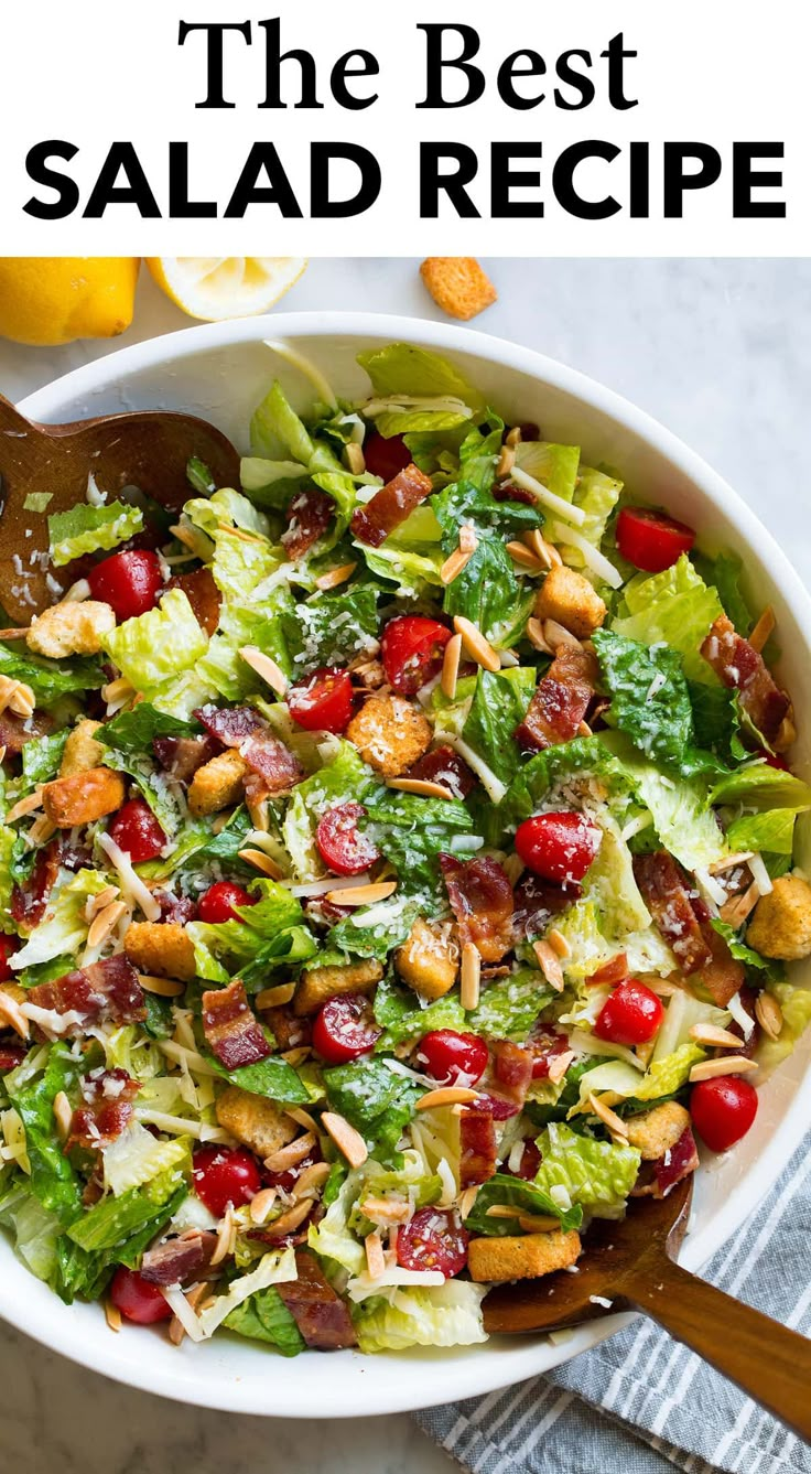 a salad with cranberries, almonds and lettuce in a white bowl