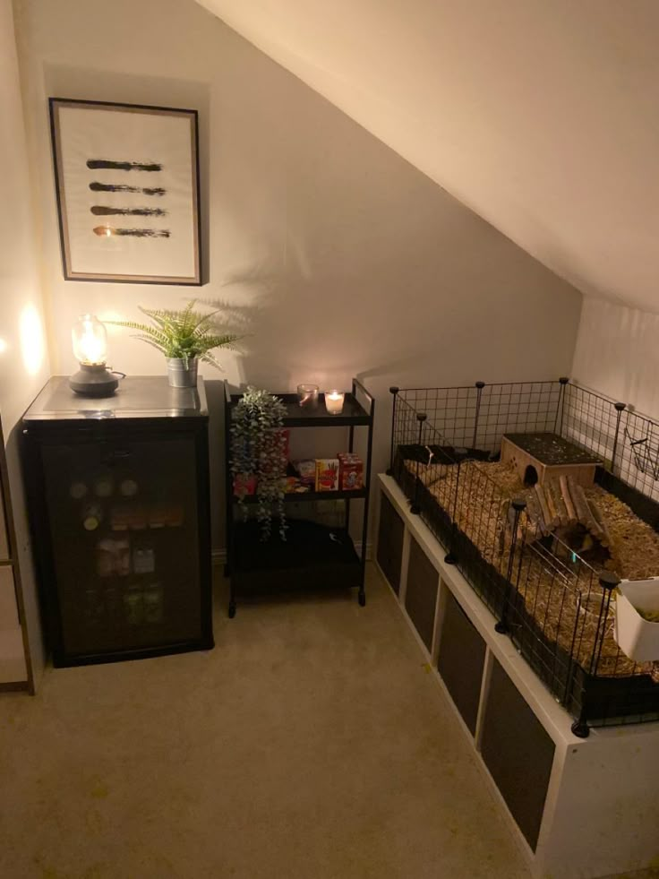 a room with two beds and a desk in it that has candles on top of them