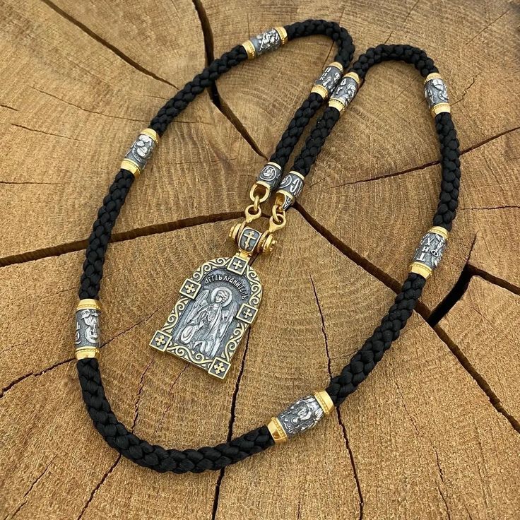 Silk cord with Orthodox gilded silver inserts and St. Paul Pendant on the adapter 1️⃣ Silk cord with Orthodox gold-plated inserts ✔️Silver 925 + 24K 999 gold plated + blackening ✔️The lace is made of lavsan fiber ✔️Diameter 5 mm ✔️Production of any length ✔️8 silver inserts depicting the faces of Saints: 🔘Nikolai the Wonderworker 🔘Holy Trinity 🔘George Victorious 🔘Mother of God 🔘Panteleimon the Healer 🔘Sergei Radonezhsky 🔘Jesus Christ 🔘Holy Matrona ✔️Save and Save endings with carabiner lock. 2️⃣Silver gilded pendant - St. Paul incense On the reverse side there is a Guardian Angel. ✔️Silver + 24K 999 gold plating + blackening ✔️Weight 21 grams (+- 1 gram) ✔️Size 49/24 mm. + adapter ✔️Possible production in: 🟡Gold 🌕24K gold plated sterling silver 🔘Silver with blackening Gold Spiritual Jewelry With Adjustable Cord, Spiritual Gold Jewelry With Adjustable Cord, Spiritual Gold Necklace With Adjustable Cord, Jesus Christus, Silk Cord, Holy Trinity, St Paul, Gift For Men, Gold Plated Sterling Silver