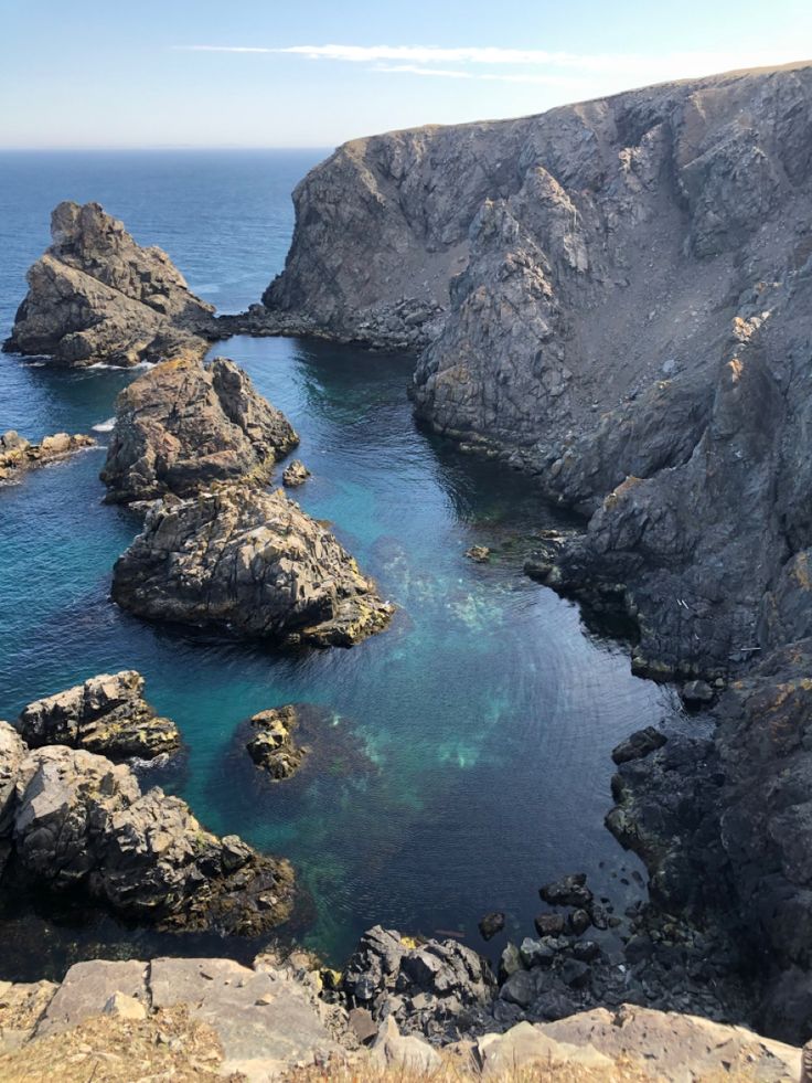 the water is blue and clear in this rocky area