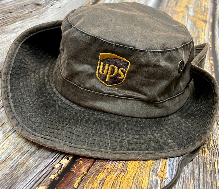 A must have for every UPS driver!! These Booney hats by Dri-Duck are perfect to keep that summer sun away!- 61/37/2 cotton/polyester/polyurethane, faux waxy canvas- Polyester mesh lining- Breathable- Brass mesh eyelets and snaps- Moisture-wicking sweatband- Suede adjuster on chin strapSize: One Size Fits Most - Hat Size: 7 1/2 - 7 5/8 Adjustable Casual Bucket Hat For Outdoor Work, Casual Brimmed Hats For Outdoor Work, Casual Bucket Hat For Outdoor Work, Casual Sun Hat With Curved Brim For Outdoor Work, Casual Curved Brim Sun Hat For Outdoor Work, Adjustable Canvas Sun Hat For Outdoor Use, Casual Brimmed Sun Hat For Outdoor Work, Vintage Canvas Hat For Outdoor, Casual Curved Brim Hat For Outdoor Work