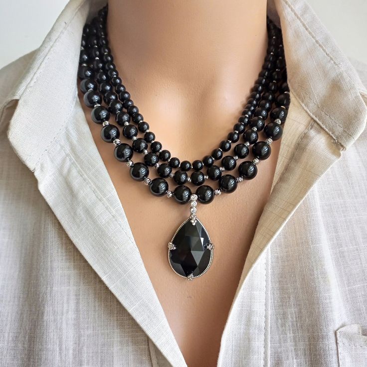 Introducing our Handmade Black Onyx Beaded Necklace, a stunning accessory designed for women who love to make a statement with their jewelry. This multi-strand piece features natural black onyx stones, creating an elegant and boho chic look that is sure to turn heads. The perfect gift for a loved one or a special treat for yourself, this necklace is a versatile addition to any wardrobe. CARE INSTRUCTIONS: To keep your necklace looking its best, avoid contact with water and harsh chemicals. Store Black Necklace Elegant, Delicate Pendant, Jewelry Elegant, Boho Chic Jewelry, Onyx Necklace, Black Onyx Stone, Black Accessories, Onyx Bead, Chic Look