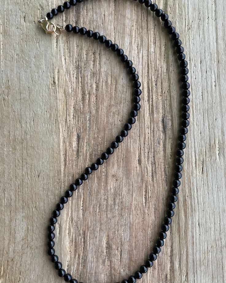 Black Onyx Necklace: Classic Beauty, Made Your Way! https://kathybankston.com/products/black-onyx-necklace-with-sterling-silver-clasp-4mm #blackonyxjewelry #blackonyxnecklace #jewelry #necklace #handmadejewelry #shopsmall #timelessjewelry #classicjewelry #texasmakers Single Strand Necklaces With Round Beads For Layering, Classic Beaded Necklaces With Round Beads For Everyday, Classic Beaded Necklaces With Round Beads, Classic Single Strand Beaded Necklaces, Elegant Black Beaded Necklace With Tiny Beads, Classic Single Strand Beaded Necklace For Everyday, Minimalist 8mm Onyx Bead Jewelry, Elegant Black Tiny Beads, Classic Adjustable Necklace With 8mm Beads