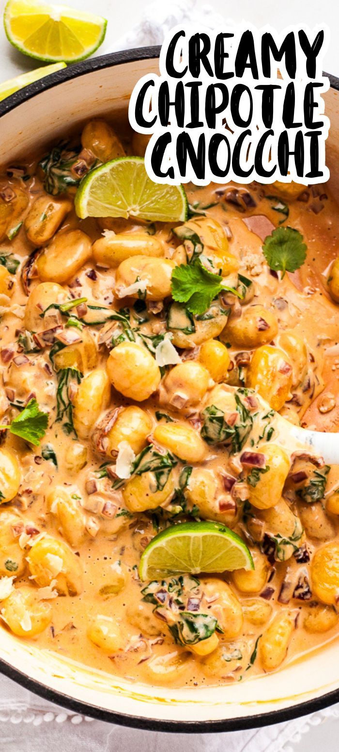 creamy chipotie enchilada in a skillet with limes and cilantro