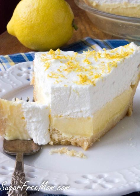 a piece of lemon pie on a plate with a fork