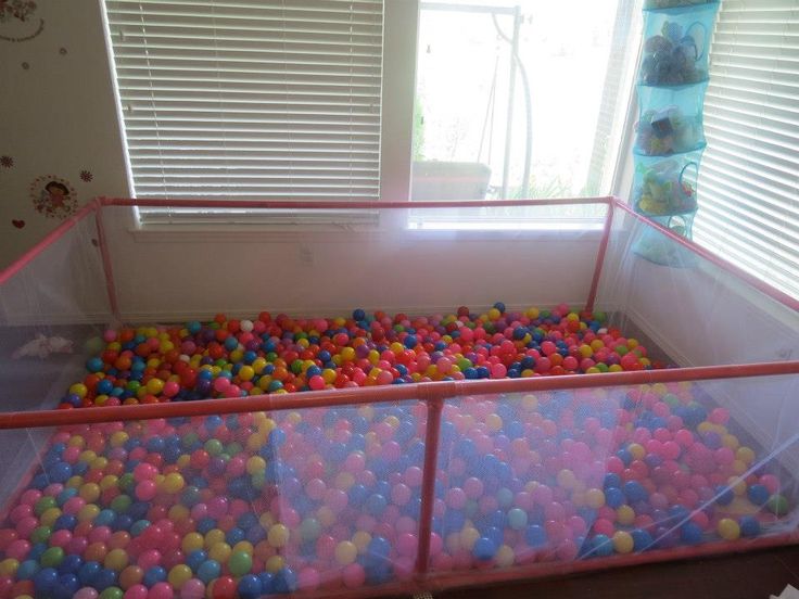 there are many balls in the playpen for babies to play with, and it's hard to tell