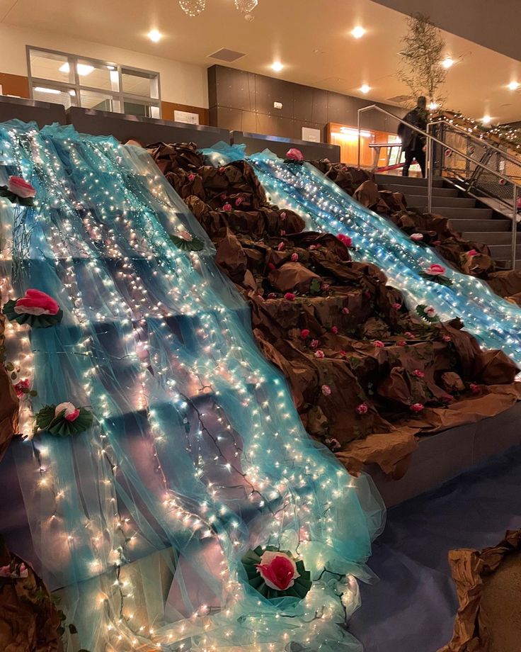 an indoor slide is decorated with lights and flowers