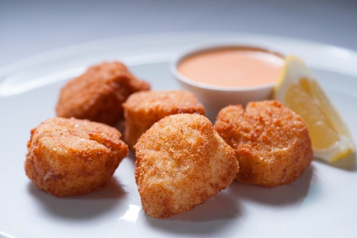 fried food on a plate with dipping sauce