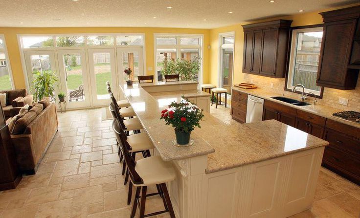 a large kitchen with an island in the middle and lots of counter space on each side