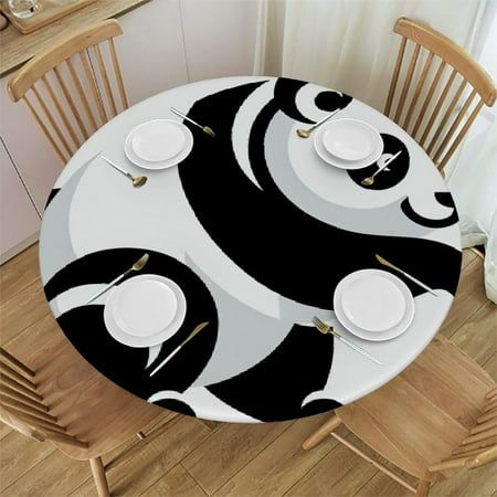 the table is set with white plates and black and white designs on it, along with wooden chairs