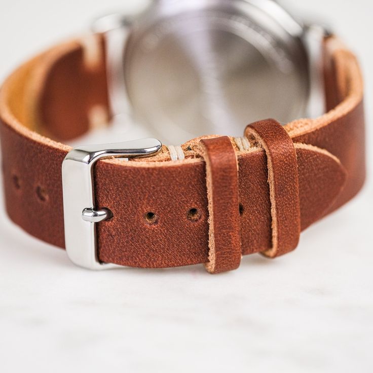 Our classic 2-piece custom watch straps feature Horween Leather in multiple color options with natural stitching. Straps feature a thumbnail style buckle and leather strap stays. As you wear your strap, you will notice how quickly it breaks in and molds to your wrist creating an incredibly comfortable fit. And with daily wear, it will deepen in color and patina becoming a piece completely unique to you.• Handmade watch band in Horween Leather• Simple stitching in Natural waxed polyester thread• Adjustable Vegetable Tanned Leather Watch Bands With Strap, Adjustable Leather Watch With Round Dial, Leather Bracelet Strap For Everyday Watch Use, Adjustable Vegetable Tanned Leather Watch Band, Adjustable Vegetable-tanned Leather Watch Bands, Adjustable Leather Watch Band With Waxed Finish, Classic Leather Watch Accessories For Everyday Use, Timeless Adjustable Leather Watch Band, Leather Watch Bands With Waxed Finish