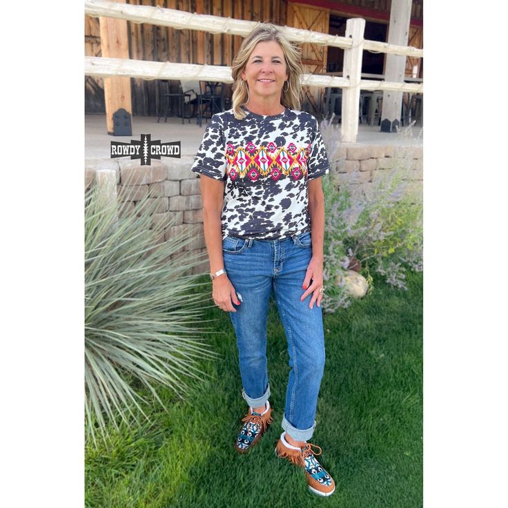 Grab your inner cowgirl with our Cowpuncher Top! This top features a charming cow print with an Aztec design in the middle, adding a unique touch. Not only is it cute, but it's also true to size and incredibly comfortable. Perfect for any Wild West adventure! 95% Polyester, 5% Spandex. Sizes Small-3XL, true to size. Western wholesale clothing. Sizing chart is available in the pictures. Casual Cow Print T-shirt For Summer, Casual Short Sleeve Cow Print Tops, Casual Cow Print Tops For Fall, Casual Cow Print Crew Neck Top, Casual Crew Neck Cow Print Tops, Trendy Cow Print Tops For Spring, Casual Spring Tops With Cow Print, Casual Cow Print Tops For Spring, Spring Casual Cow Print Tops