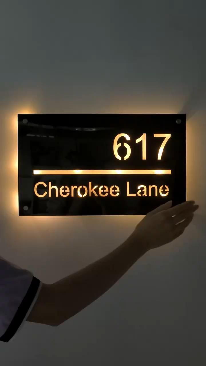 a person holding up a sign that reads 617 cheroke lane