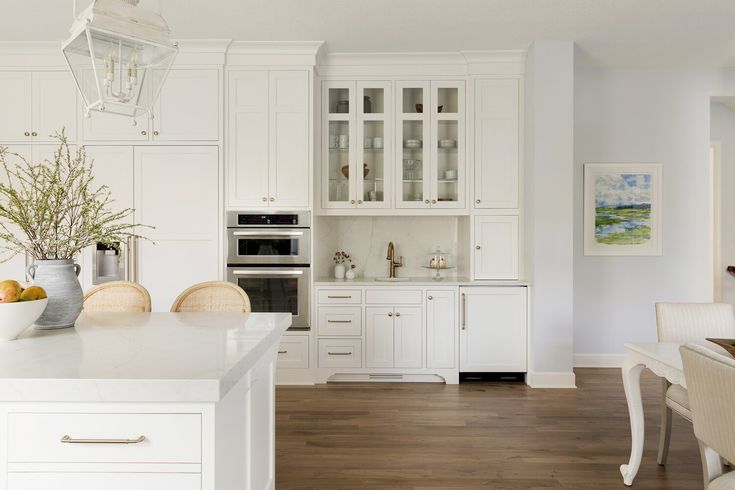 the kitchen is clean and ready for us to use it's white cabinetry