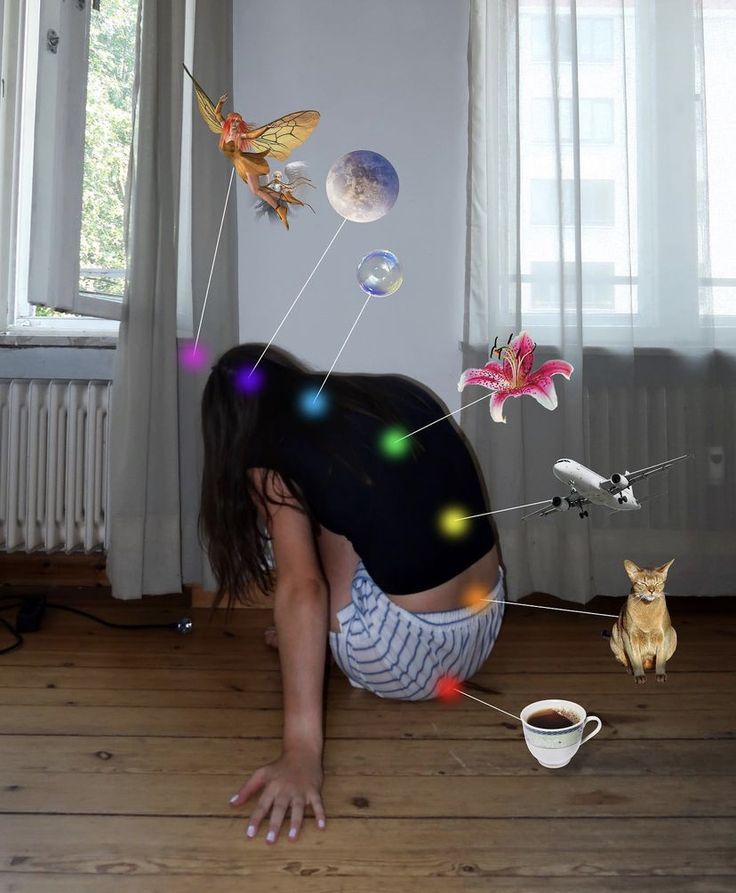 a woman bending down on the floor in front of a coffee cup and flying objects