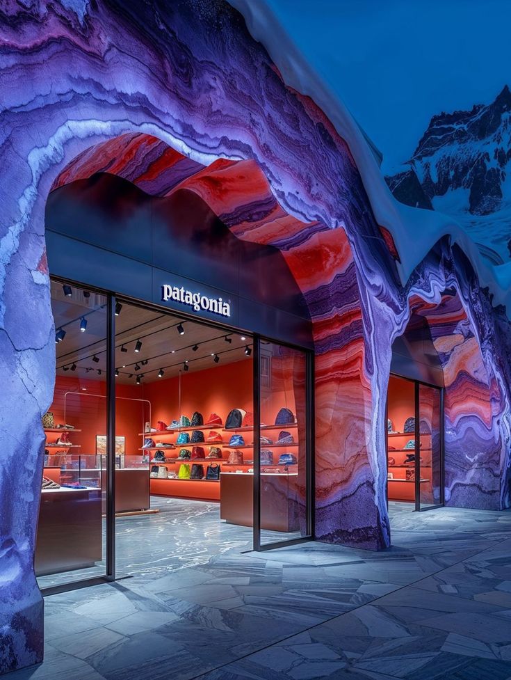 the entrance to patagoniaia is lit up at night with red and purple lights