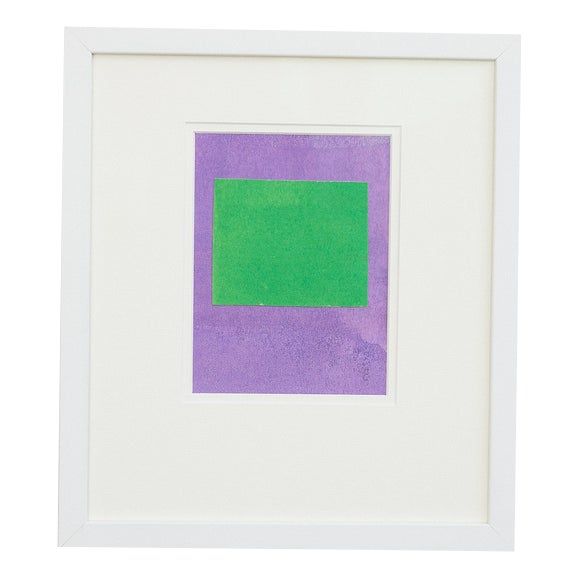 a purple and green square in a white frame on a white wall with a black border