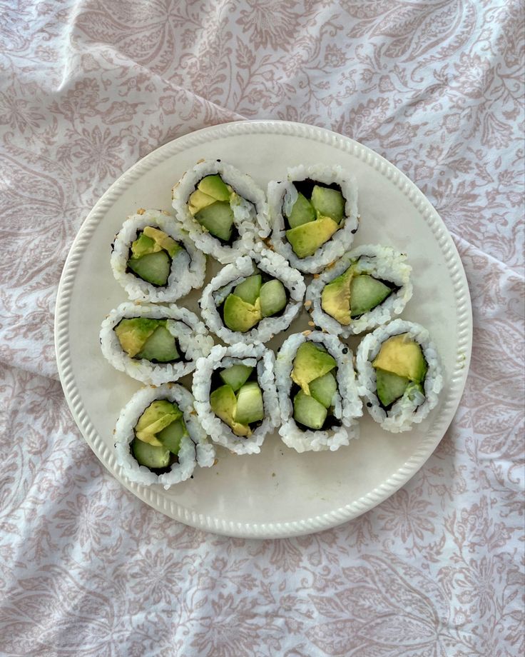 sushi rolls are arranged on a white plate