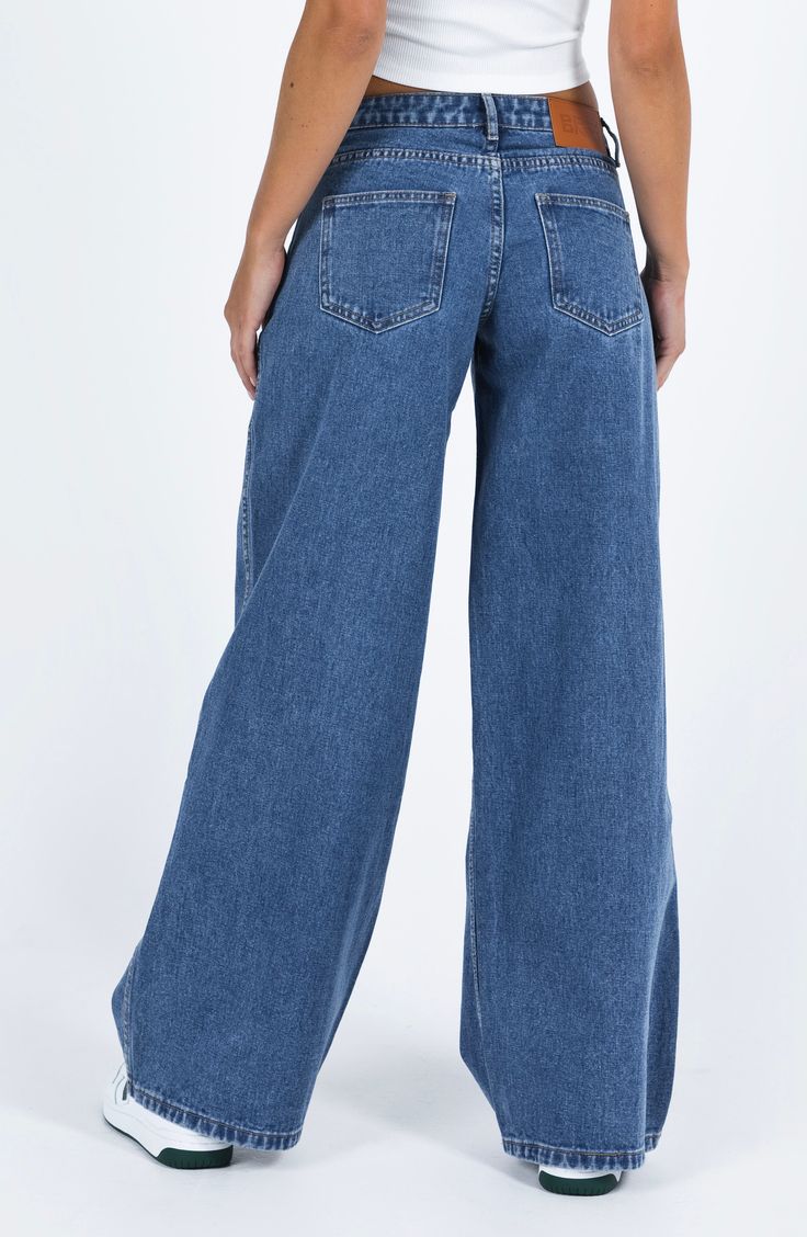 Flaunt vintage vibes in these medium-wash nonstretch jeans featuring a low-rise waist and full-length wide legs. 31 1/2" inseam; 26" leg opening; 10 1/2" front rise; 14" back rise (size 8) Zip fly with button closure Five-pocket style 70% cotton, 15% viscose, 15% polyester Machine wash, line dry Imported Wide Jeans Outfit High Waist, Medium Wash Jeans Outfit, Winter Drama, Baggy Jeans Aesthetic, Wide Jeans Outfit, Wash Jeans Outfit, Low Rise Wide Leg Jeans, Fun Jeans, Ultra Low Rise Jeans