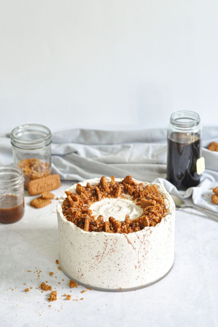 a cake sitting on top of a white table covered in frosting and toppings