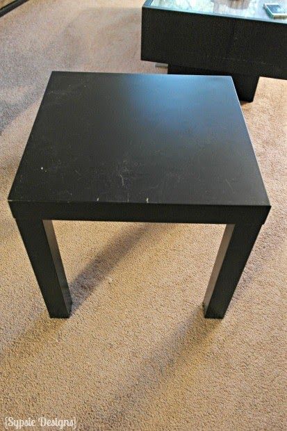 two black tables sitting on top of a carpeted floor