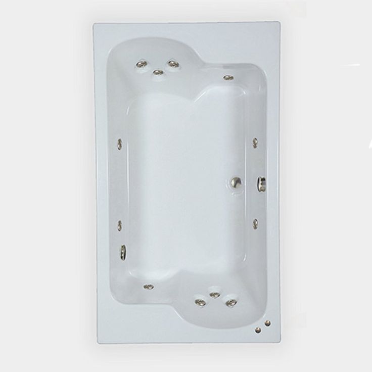 an empty white bath tub in the corner of a wall with screws on it