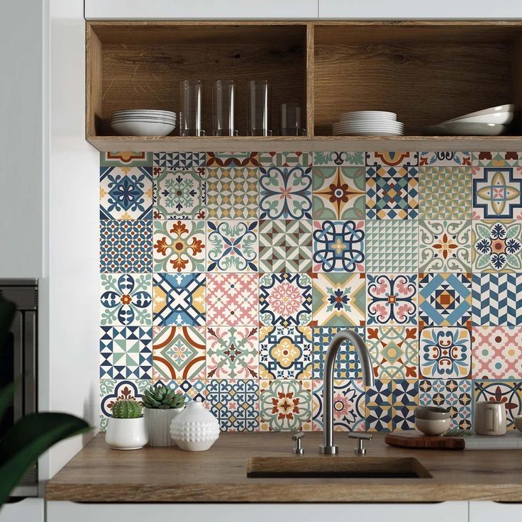 a kitchen with colorful tiles on the backsplash and wooden shelves above it,