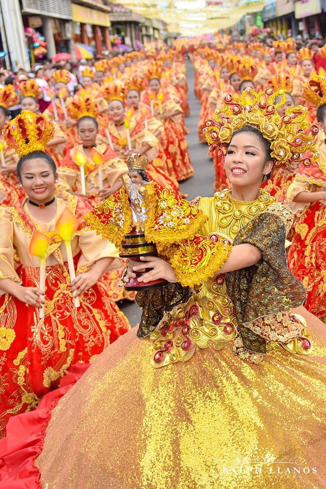 a group of women in yellow and red dresses