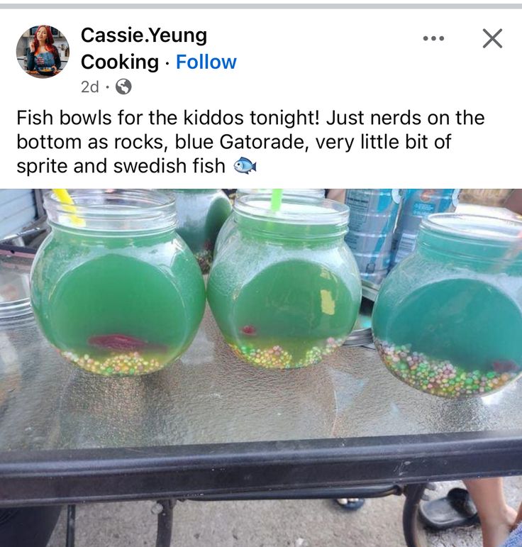 two fish bowls filled with green liquid and sprinkles on top of a table