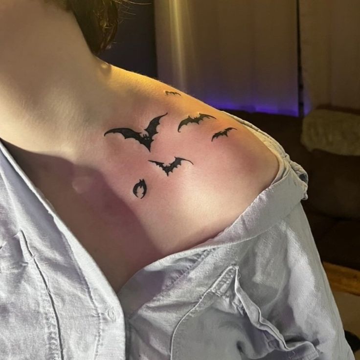 a woman with a bat tattoo on her shoulder