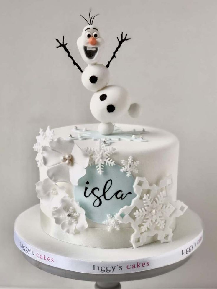 there is a cake that has been decorated with snowflakes and a name on it