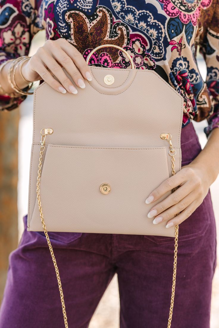 This taupe purse is the definition of classic and chic! The contrasting fabric is gorgeous and we love the gold hardware. This clutch is going to look amazing with so many dressier outfits. Classic Taupe Shoulder Bag For Evening, Classic Taupe Evening Bag, Classic Beige Clutch With Gold-tone Hardware, Chic Clutch With Gold-tone Hardware, Elegant Cream Crossbody Clutch, Taupe Shoulder Bag With Gold-tone Hardware For Formal Occasions, Chic Brown Clutch With Chain Strap, Elegant Taupe Crossbody Shoulder Bag, Chic Taupe Shoulder Bag For Formal Occasions