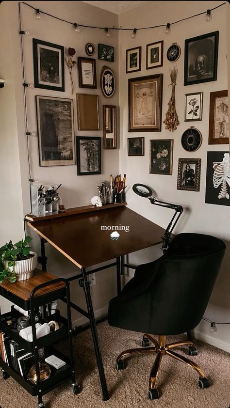 a desk with a chair and pictures on the wall