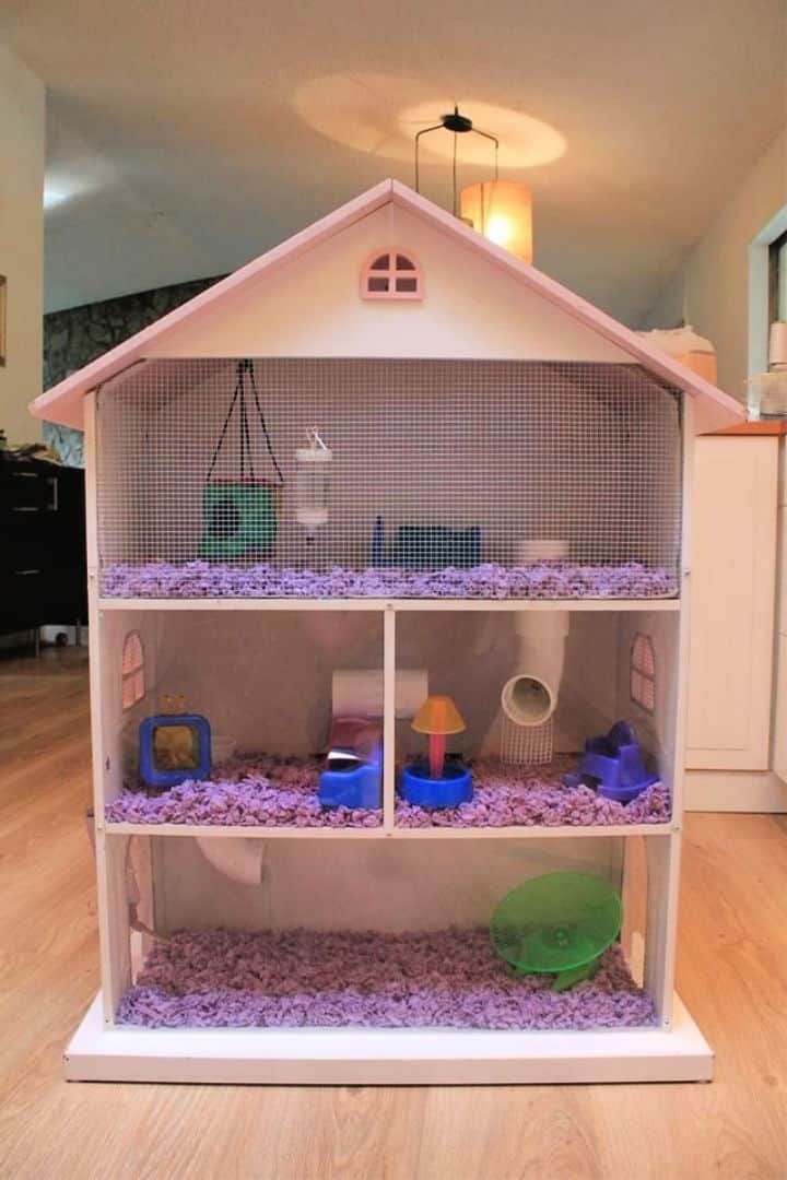 a house made out of some kind of shelf filled with purple rocks and other items