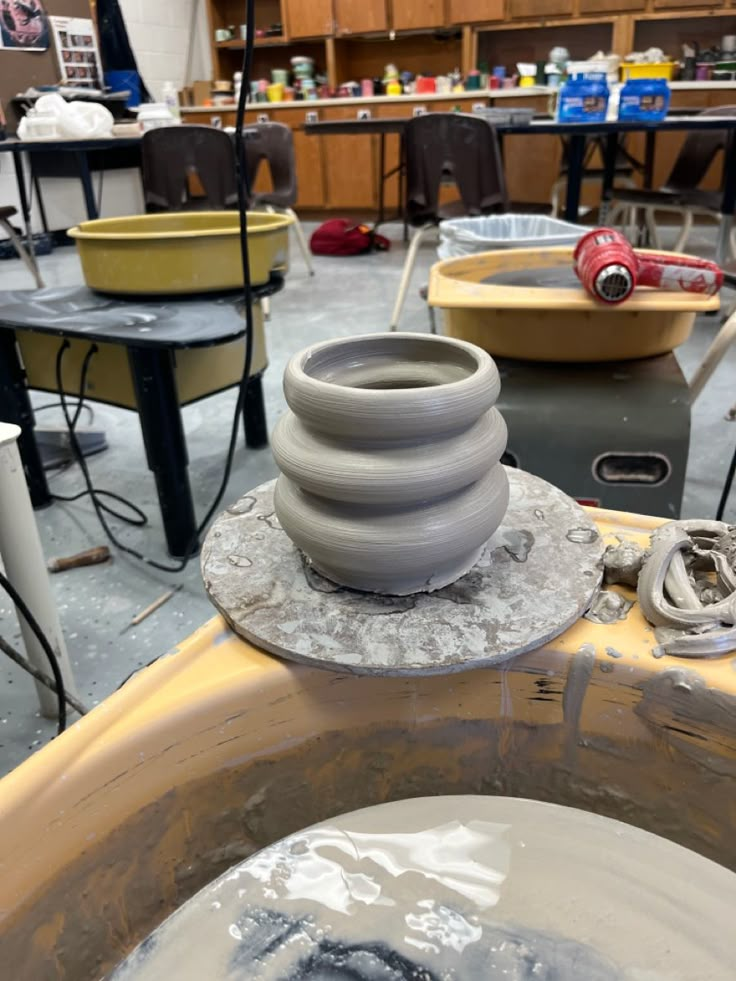 the pottery wheel is sitting on top of the work bench in the studio, ready to be made