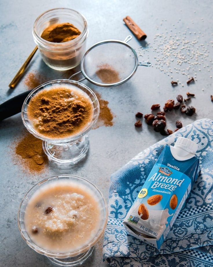 the ingredients to make an almond butter smoothie are shown in small glass bowls on a blue and white towel