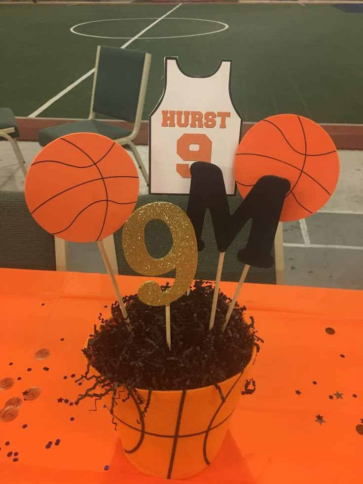 a basketball themed centerpiece sits on top of a table