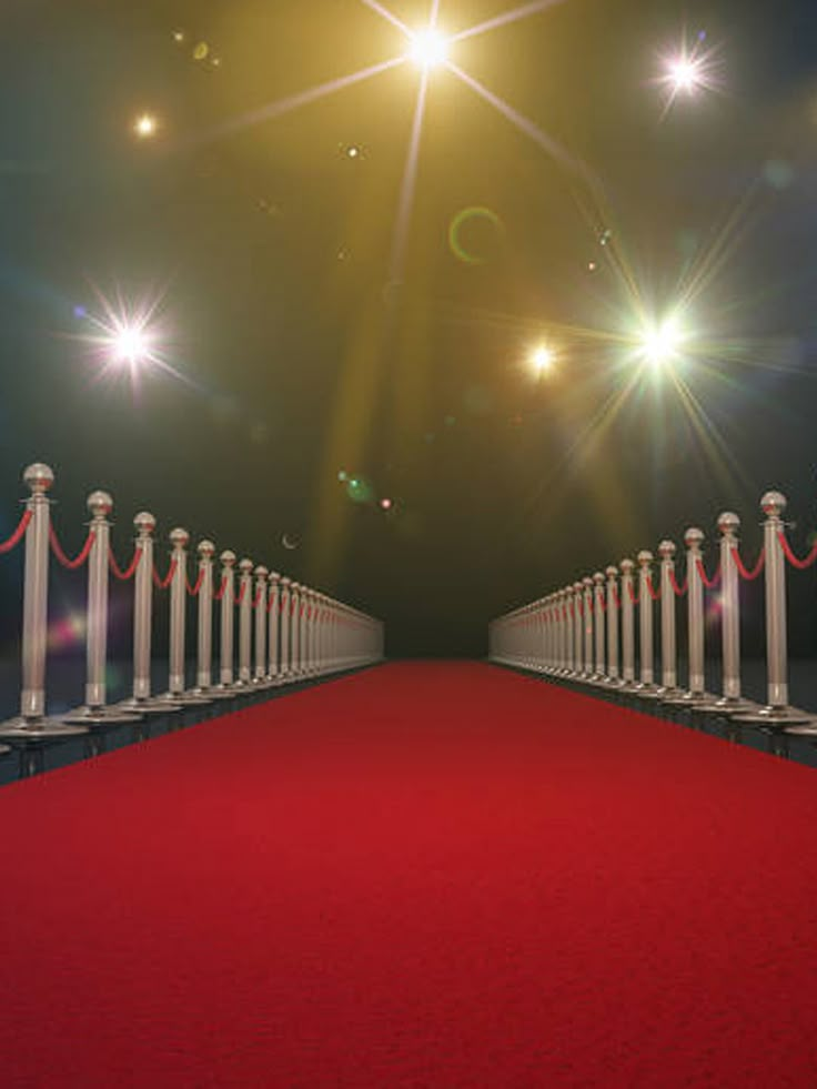 a red carpeted walkway with white railings leading to bright lights and stars in the sky