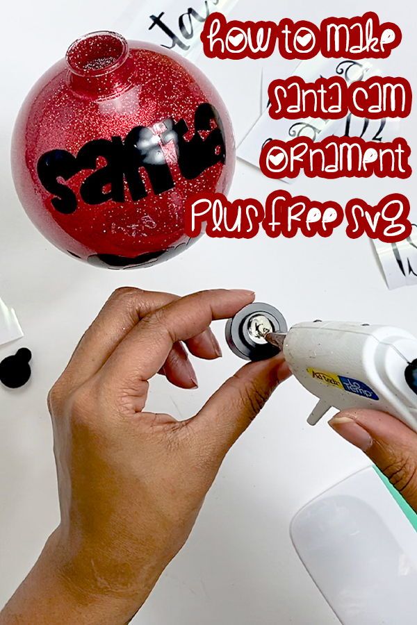 a hand holding a hair dryer near a christmas ornament with the words sale written on it