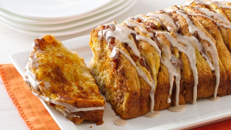 a white plate topped with bread covered in icing